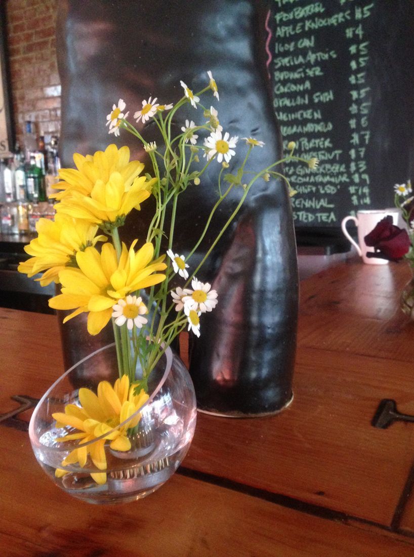 delicate arrangement of yellow flowers on a bar