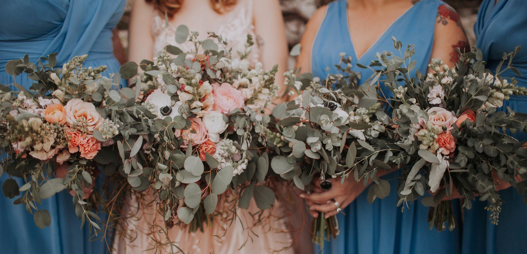 row of bridesmaids with bouquets in pale green and pink