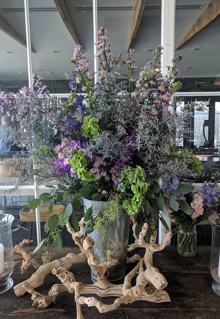 springtime arrangement of purple flowers, driftwood