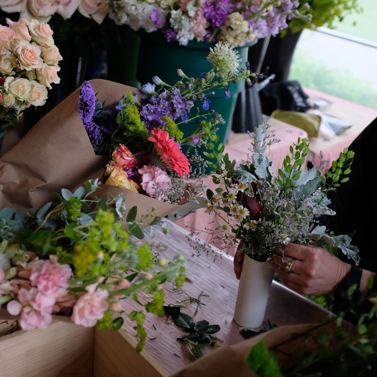pop-up flower market, rebecca arranging greens in a vase